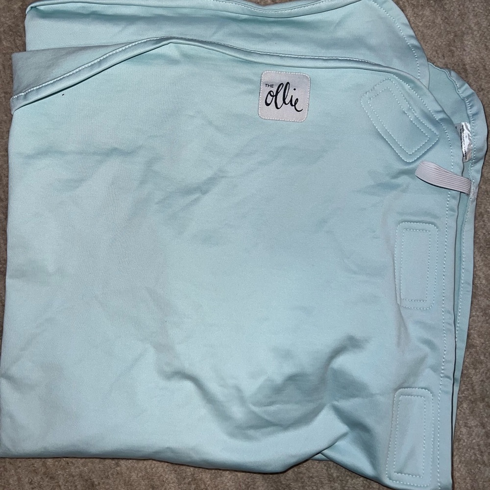 Brand new blue Ollie brand swaddle.